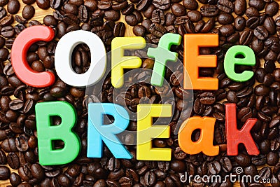 Itâ€™s time for coffee break concept with colourful text on roasted coffee beans background Stock Photo